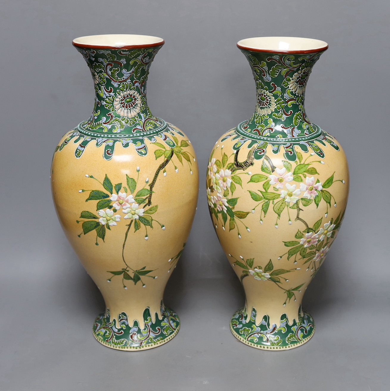 A pair of Japanese Satsuma style cream ground moriage vases, 40cm